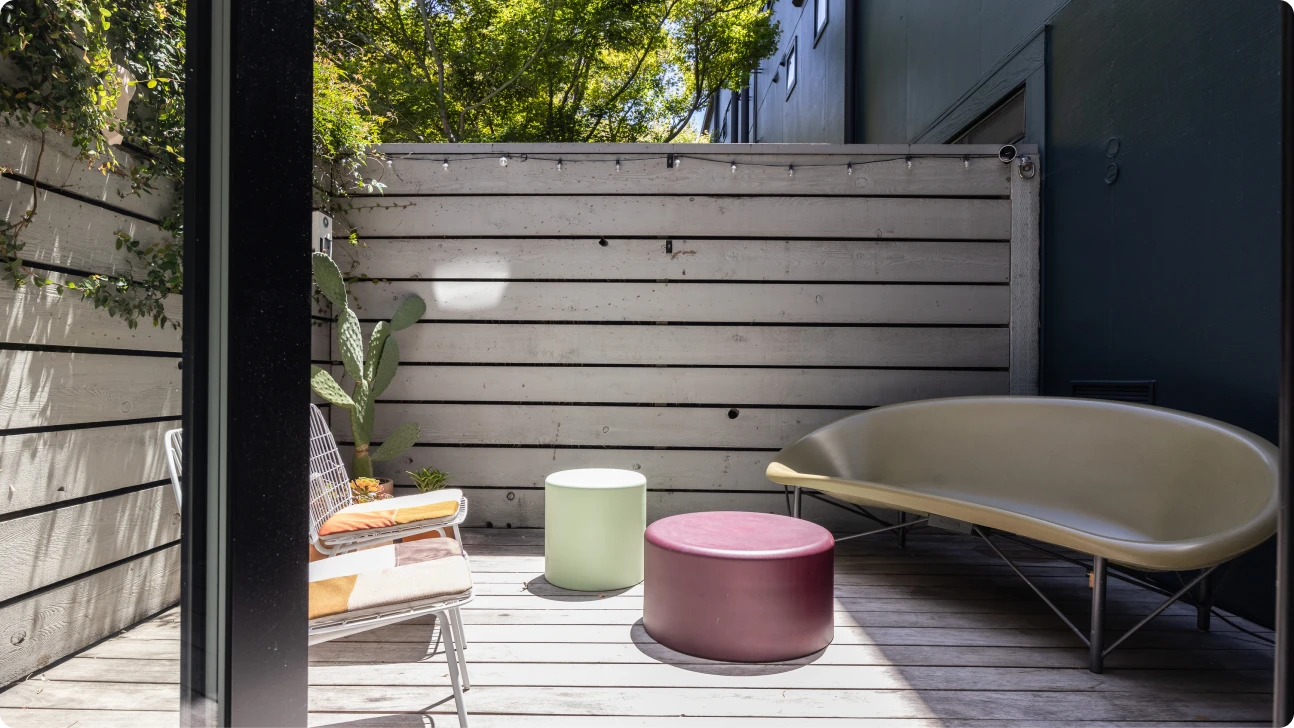 Sunlit private deck with modern seating and wood privacy fence, Bay Area outdoor living upgrade by Mission Home Remodeling.