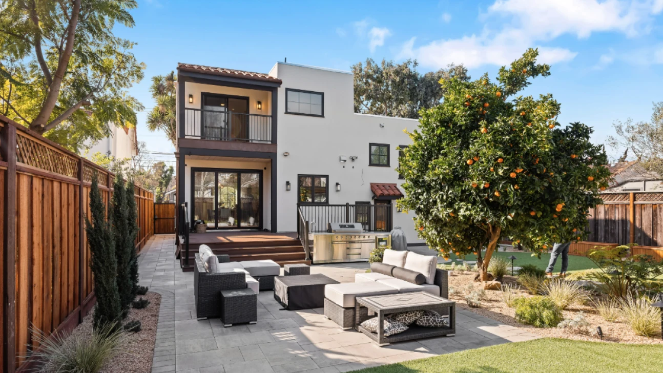 Stylish backyard patio and lush garden at a Bay Area home remodel with outdoor seating and citrus tree