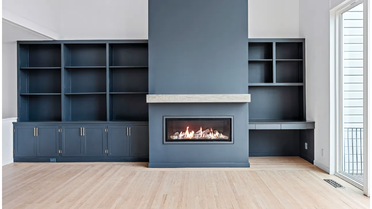Elegant built-in bookcases flanking a linear fireplace, light wood floors, and refined finishes in San Francisco remodel
