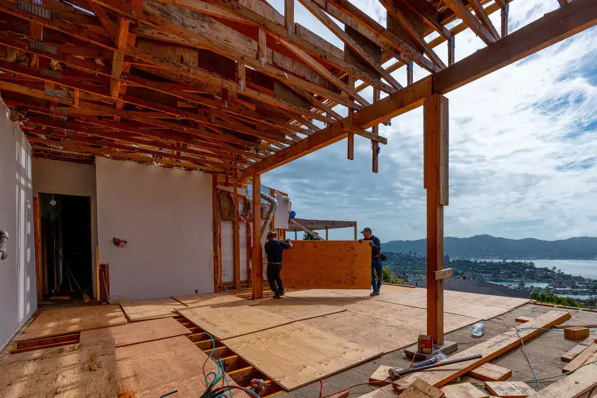 Residential home under construction with exposed wood framing and roof structure