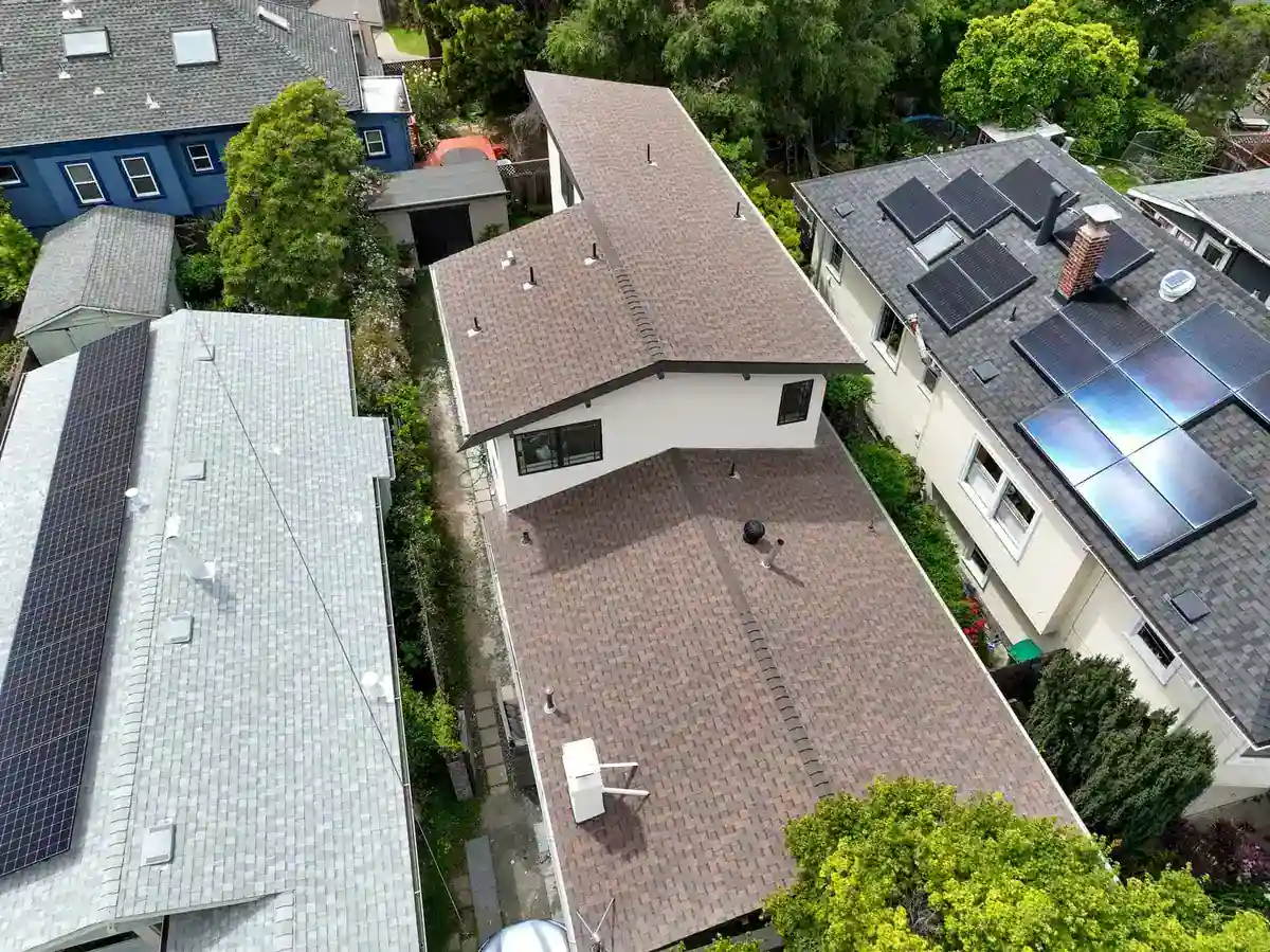 Aerial view of a partial second story addition on a narrow lot, built over the rear of a single-story home between neighbors.